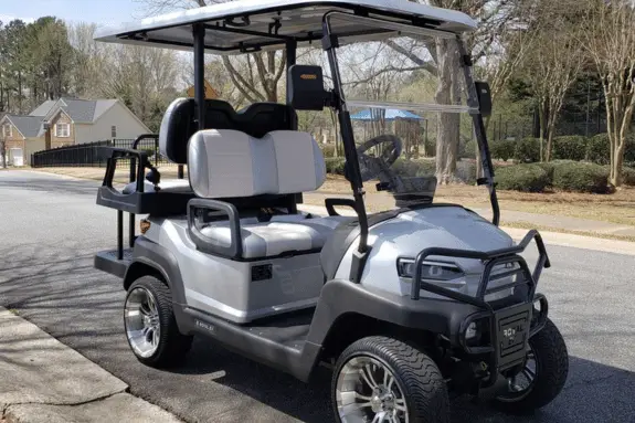 example of a silver royal ev golf cart with an extended roof and bumper guard