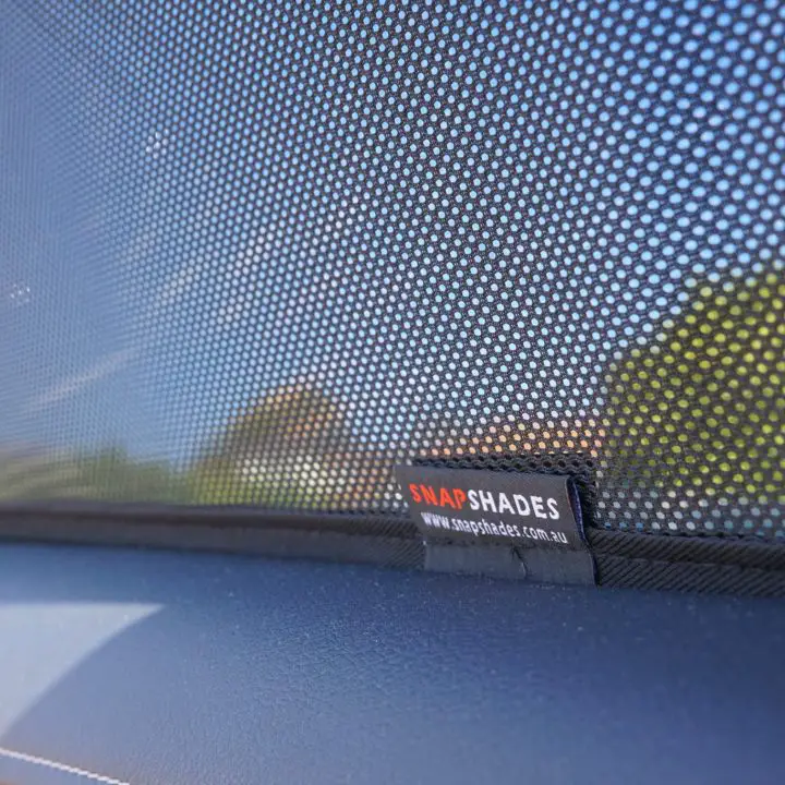 an example of a snap shades product being used to keep a car cool by blocking the windows.