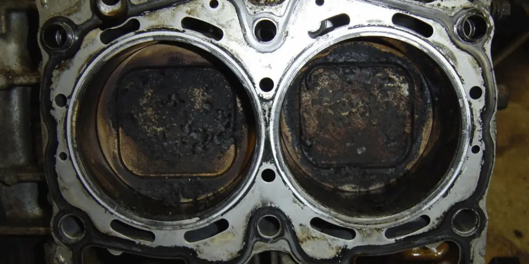 Subaru cylinders that are covered in carbon build up due to an internal coolant and oil leak from a faulty head gasket